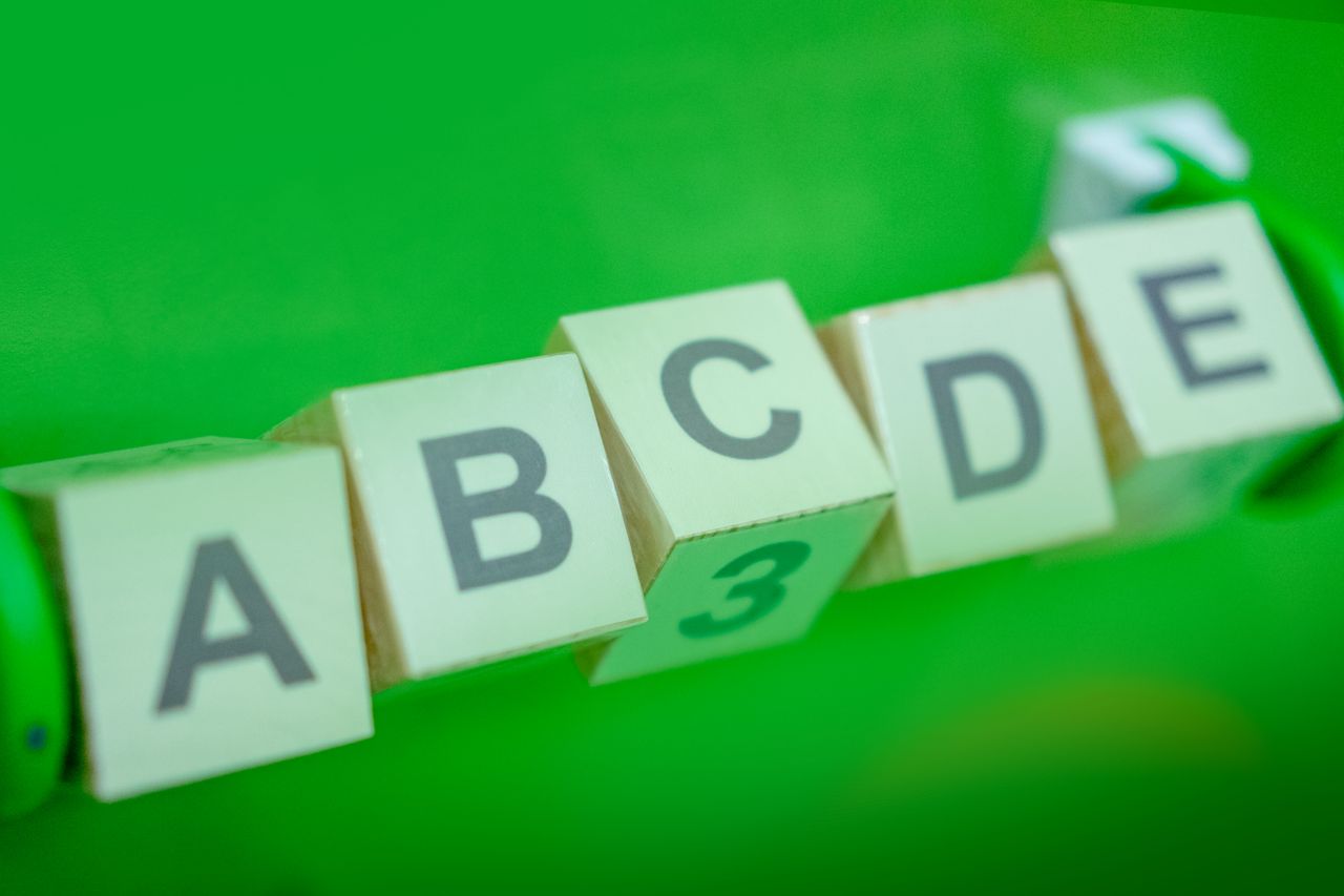 Home Close-up of alphabet blocks arranged with a green background, perfect for educational themes.